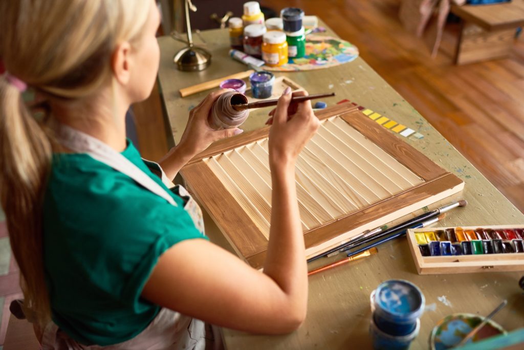 Young Woman Painting Furniture in Art Studio